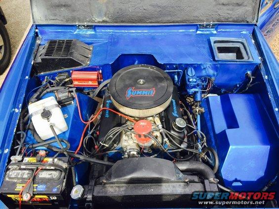 Blue painted engine bay with Summit air cleaner and V8 engine. Battery and radiator visible