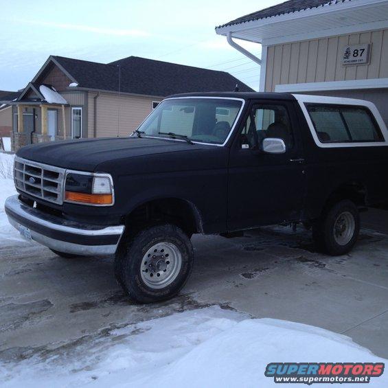 Black 1992 Ford Bronco parked in a driveway with snow on the ground