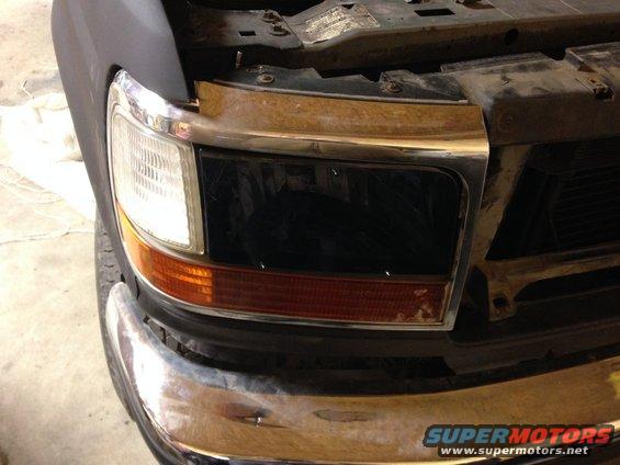 Front end of a 1992 Ford F-Series truck with a chrome bumper and black grille