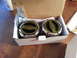 1981 Ford Bronco - Two new Warn locking hubs are shown in their original packaging, ready for installation.