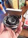 1981 Ford Bronco - A chrome Warn Hub assembly with internal components is held in a hand, with boxes in the background.