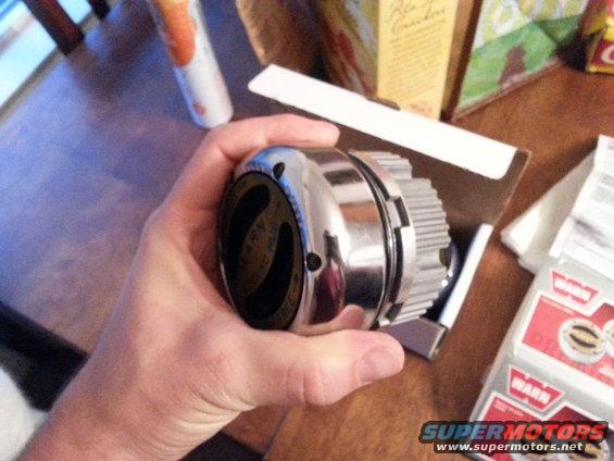 Chrome Warn locking hub held in hand, with box and stickers visible