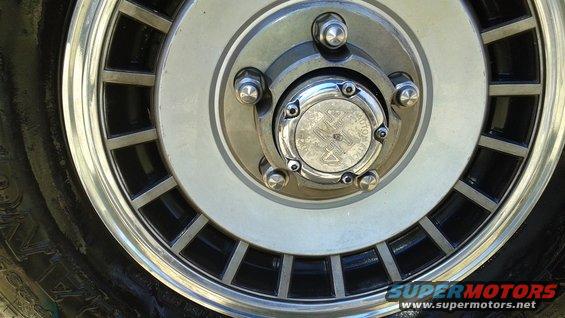Close-up of a 1988 Ford Bronco wheel with a chrome hubcap