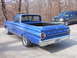 1965 Ford Ranchero - Rear view of a blue 1965 Ford Ranchero pickup truck, parked outdoors with a dark SUV in the background.