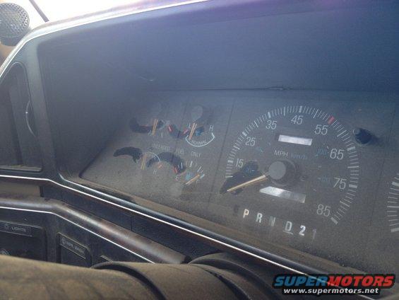 1987 Ford Bronco dashboard with dusty gauges and PRND21 selector