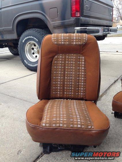 Brown plaid and vinyl bucket seat in front of a 1982 Ford Bronco
