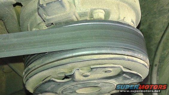 Close-up of a serpentine belt on a pulley, likely part of an engine