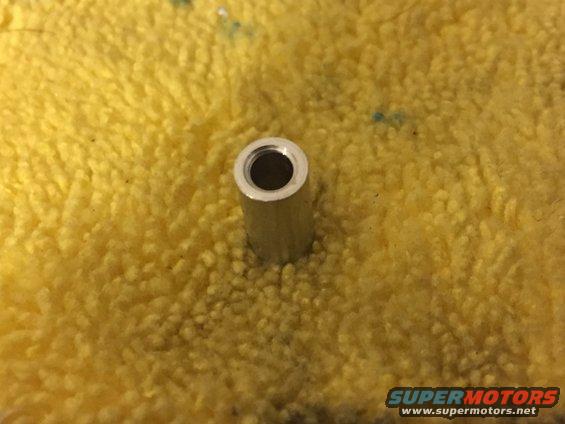 Metal spacer on yellow textured cloth