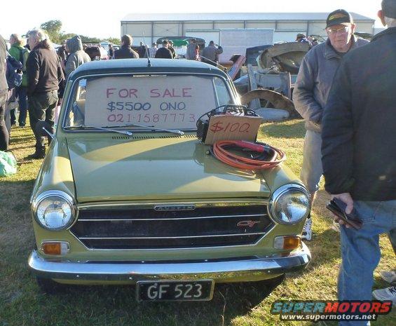 Austin GT with 'FOR SALE' sign in windshield and $100 sign on hood