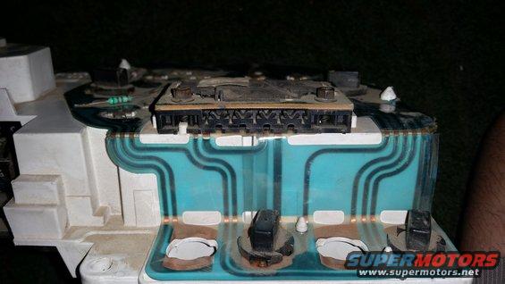 Back of a vehicle's instrument cluster showing circuit board and connectors