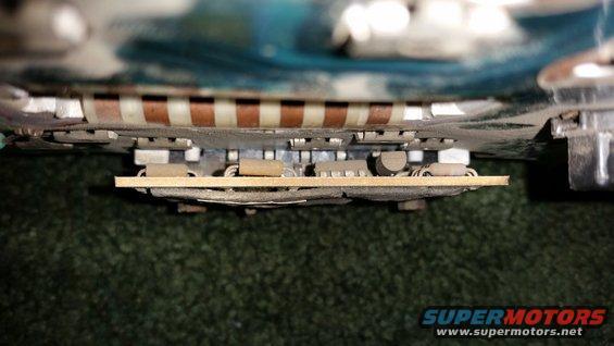 Close-up of an electronic circuit board with brown and white striped components and small silver components