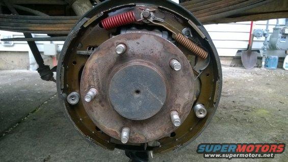 Rear drum brake assembly with red and brown springs