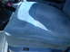 1979 Ford Bronco - The interior of a vehicle shows a blue fabric seat with a shadow cast across it.