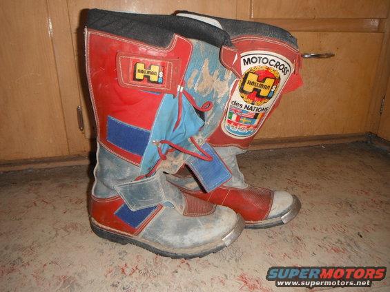Pair of red, blue, and gray Hallman motocross boots with "Motocross des Nations" patch