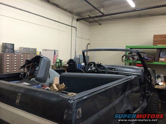 1992 Ford Bronco interior with dashboard, steering wheel, and seats visible. Rear bed is also shown