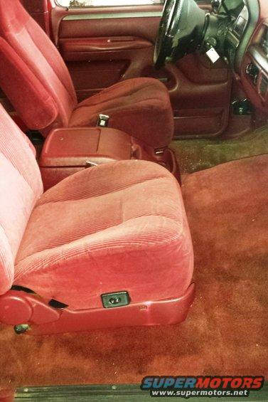 Red velour seats and carpet inside a truck cab. Shows driver's seat, passenger seat, and center console