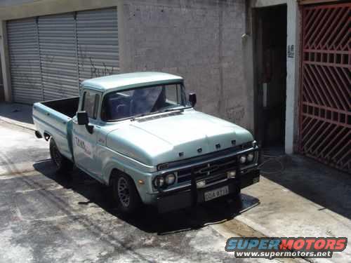 Light blue 1967 Ford F-100 pickup truck, front 3/4 view, parked on a paved surface