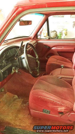 Red interior with cloth seats and steering wheel