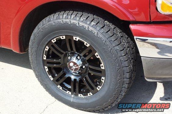 2001 Ford F-150 custom black wheel with skull center cap and Hankook tire