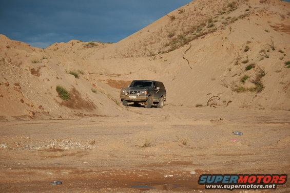 1987 Ford Bronco 3q-front view in sandy landscape