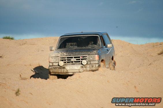 1987 Ford Bronco stuck in sand, front view