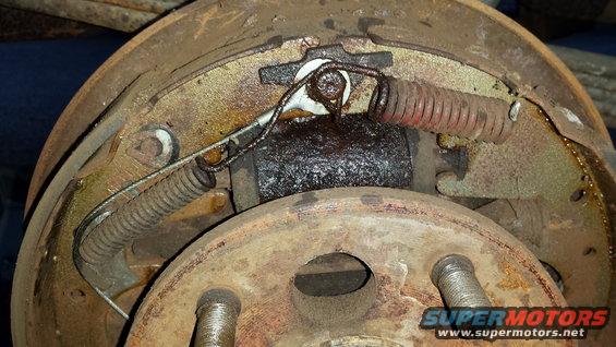 Drum brake assembly with rusted springs and grease