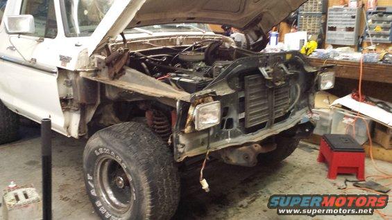 1978 Ford Bronco front end disassembled in a garage, hood open