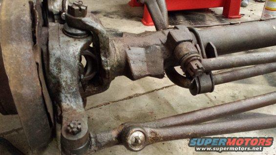Front axle and steering linkage with visible rust