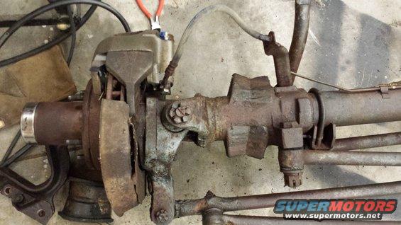 Front axle assembly with brake caliper and brake lines, rusty