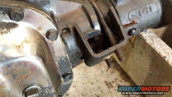 Close-up of a metal differential housing with bolts and some rust