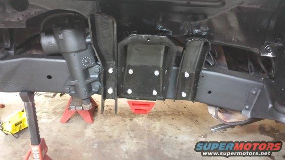 Close-up of vehicle frame with steering box and suspension components