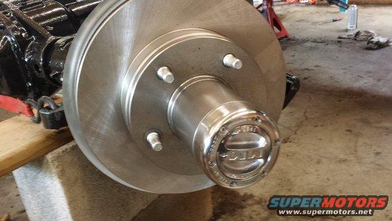 Close-up of a shiny Ford Bronco hubcap on a brake rotor assembly