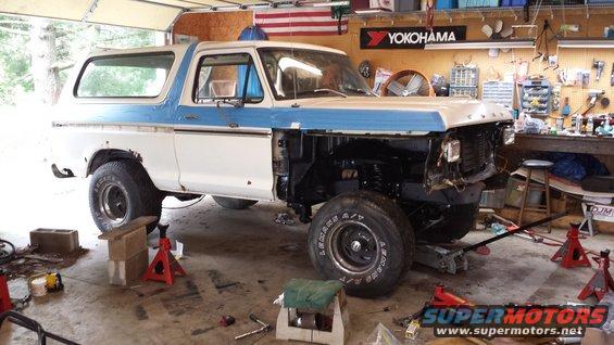1978 Ford Bronco in garage, front end disassembled, hood removed, on jack stands