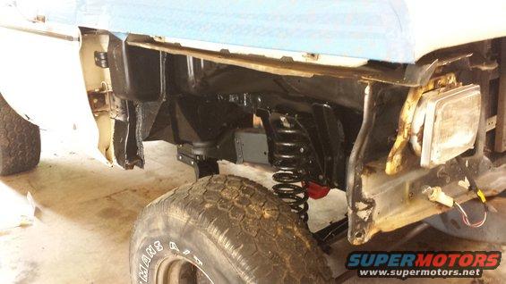 1978 Ford Bronco front fender and suspension during repair. SuperMotors.net logo visible