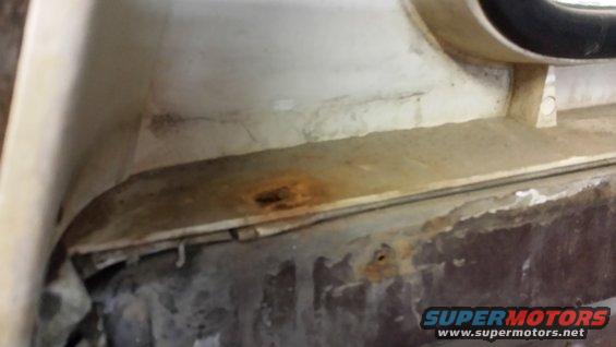Close-up of rust and grime on the interior of a vehicle, possibly near a window frame