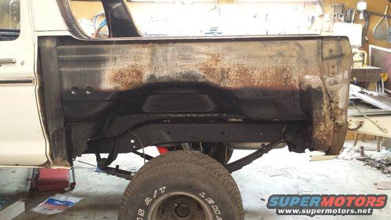 1978 Ford Bronco rear quarter panel showing rust damage and suspension components