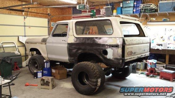 1978 Ford Bronco in garage with body filler on rear quarter panels and doors removed