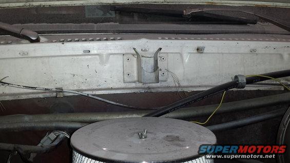 Engine bay with air cleaner, hoses, and windshield wipers visible