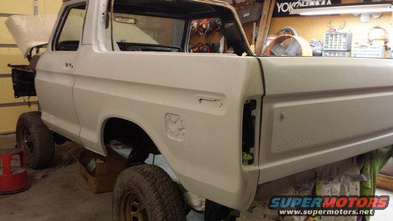 White 1978 Ford Bronco, 3q-front view, in garage for restoration