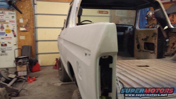 1978 Ford Bronco body, primed and in a garage, viewed from the side