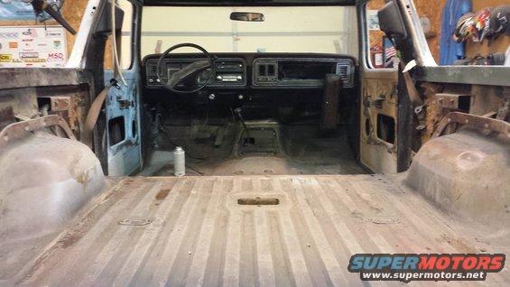 Interior of a 1978 Ford Bronco, showing the dashboard, steering wheel, and empty cargo area