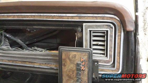 1978 Ford Bronco XLT interior dashboard panel with woodgrain trim and a vent