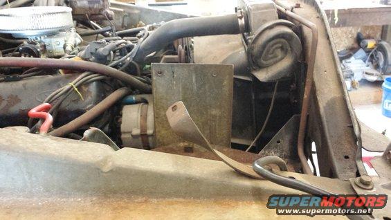 1978 Ford Bronco engine bay with carburetor, alternator, and radiator hoses visible