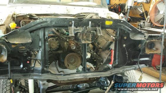 1978 Ford Bronco engine bay with front end removed, showing engine components and black metal frame