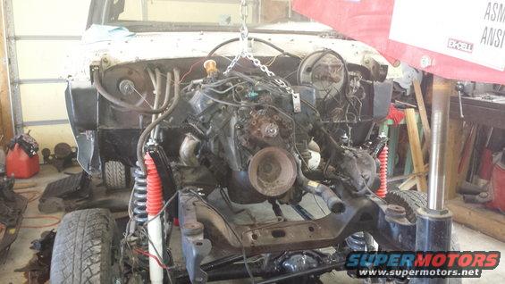 engine being lifted out of a vehicle frame