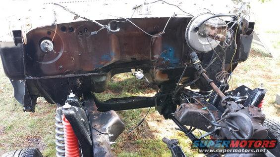vehicle frame with engine bay exposed, brake booster visible