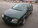 2000 Volkswagen Jetta - A dark green 2000 Volkswagen Jetta is parked outdoors, showing its front and side profile.