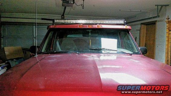 1994 Ford Bronco front view, red, with aftermarket light bar on roof