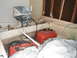 1963 Lund WC 14 - Interior view of a boat containing an outboard motor, fuel cans, and fishing equipment.