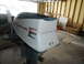 1963 Lund WC 14 - An Evinrude Fastwin outboard motor is shown in a garage setting, with "Evinrude" and "Fastwin" text visible on its casing.